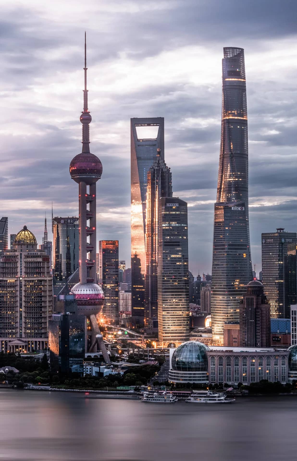 Shanghai's Pudong skyline glowing beside the Huangpu River at dusk