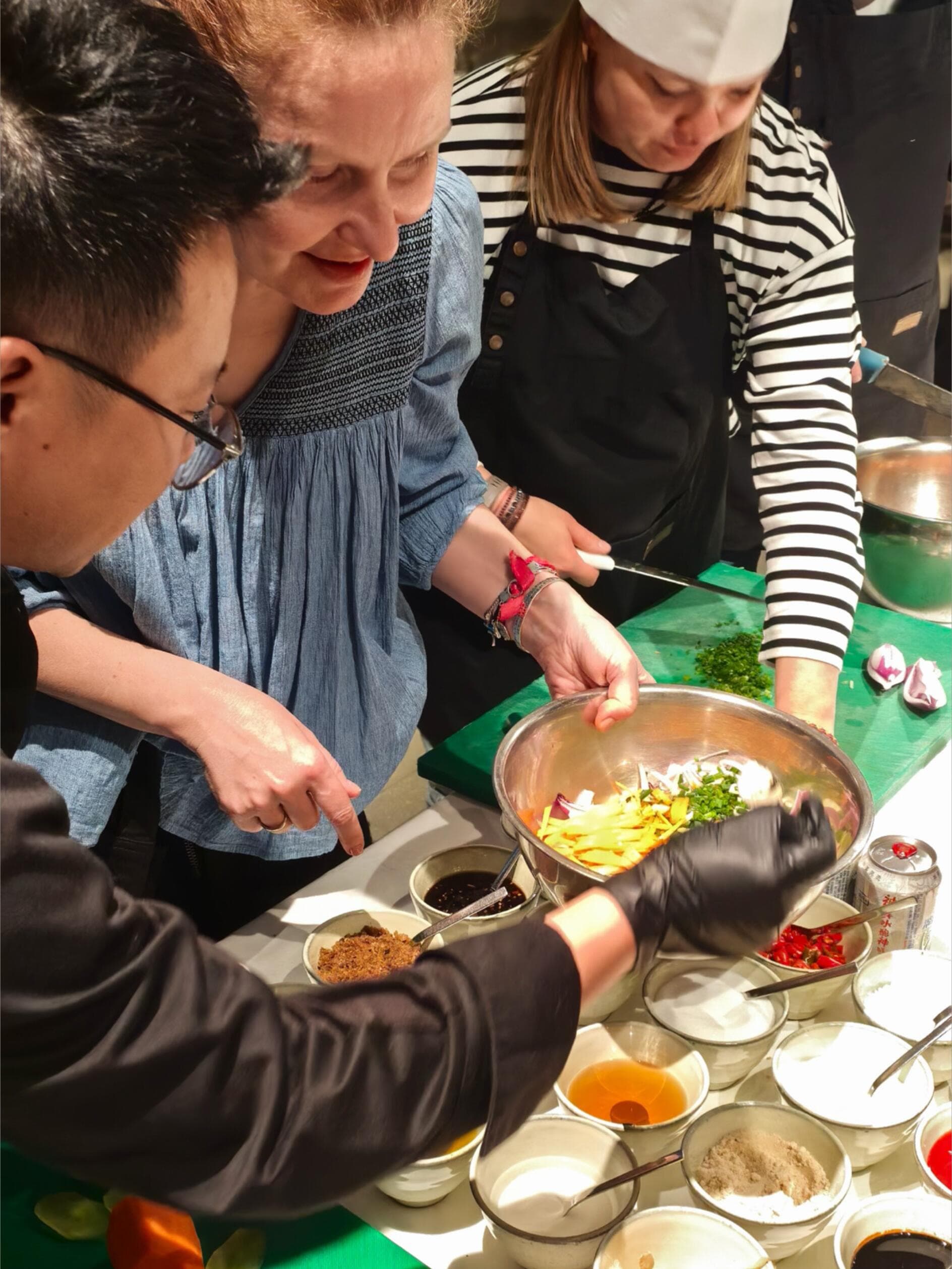 International guests learning to prepare Chinese food with a local host