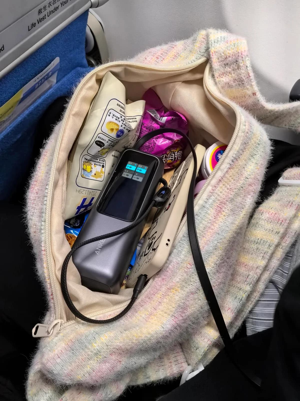 Power bank and charging cable inside a passenger's carry-on bag