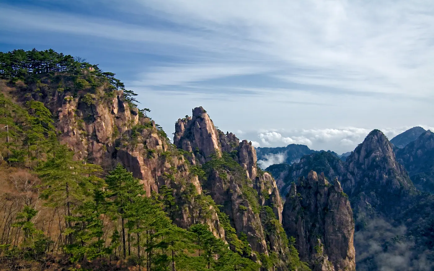 Huangshan mountain peaks rising through bright clouds