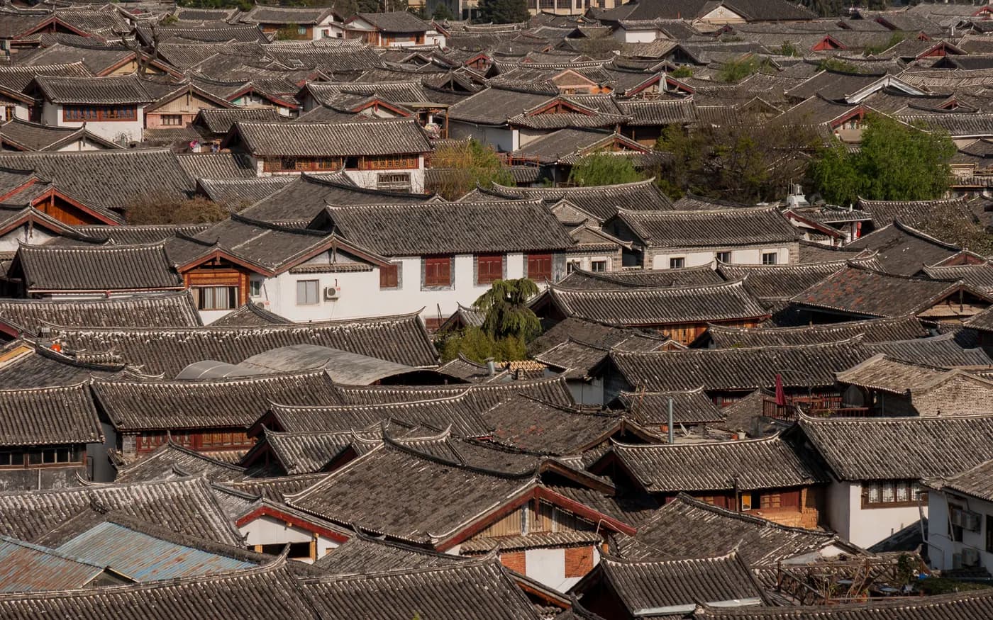 Lijiang Old Town rooftops and mountain light in Yunnan