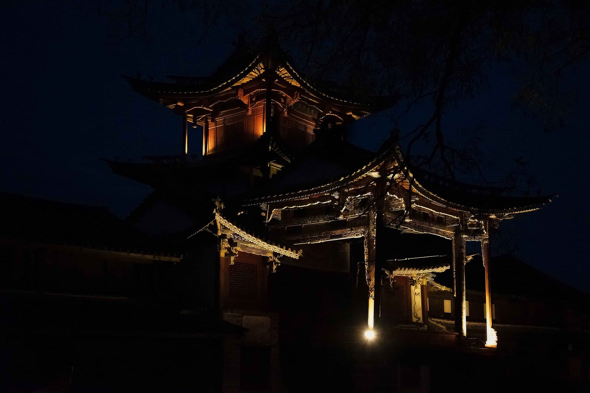 Historic timber architecture illuminated at night in Shaxi