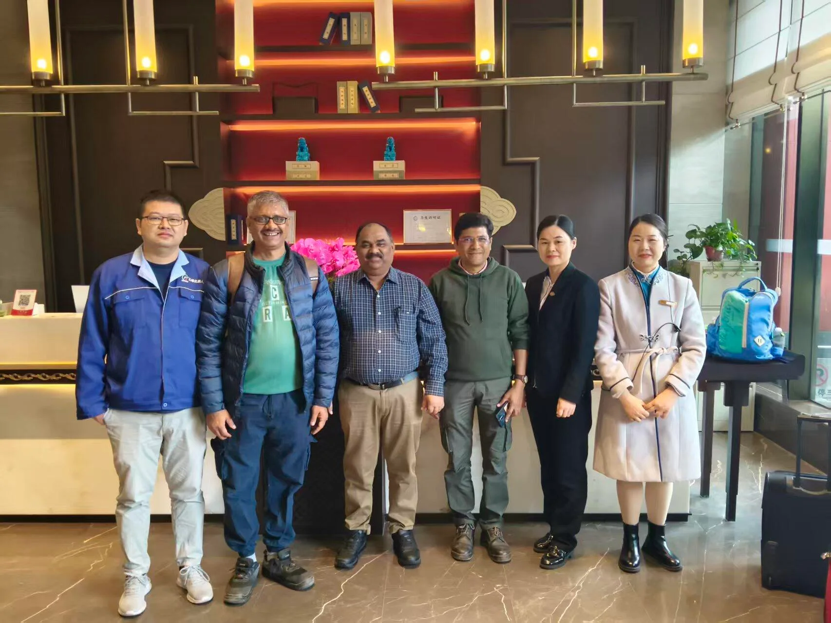 International guests with hotel staff at a reception in China