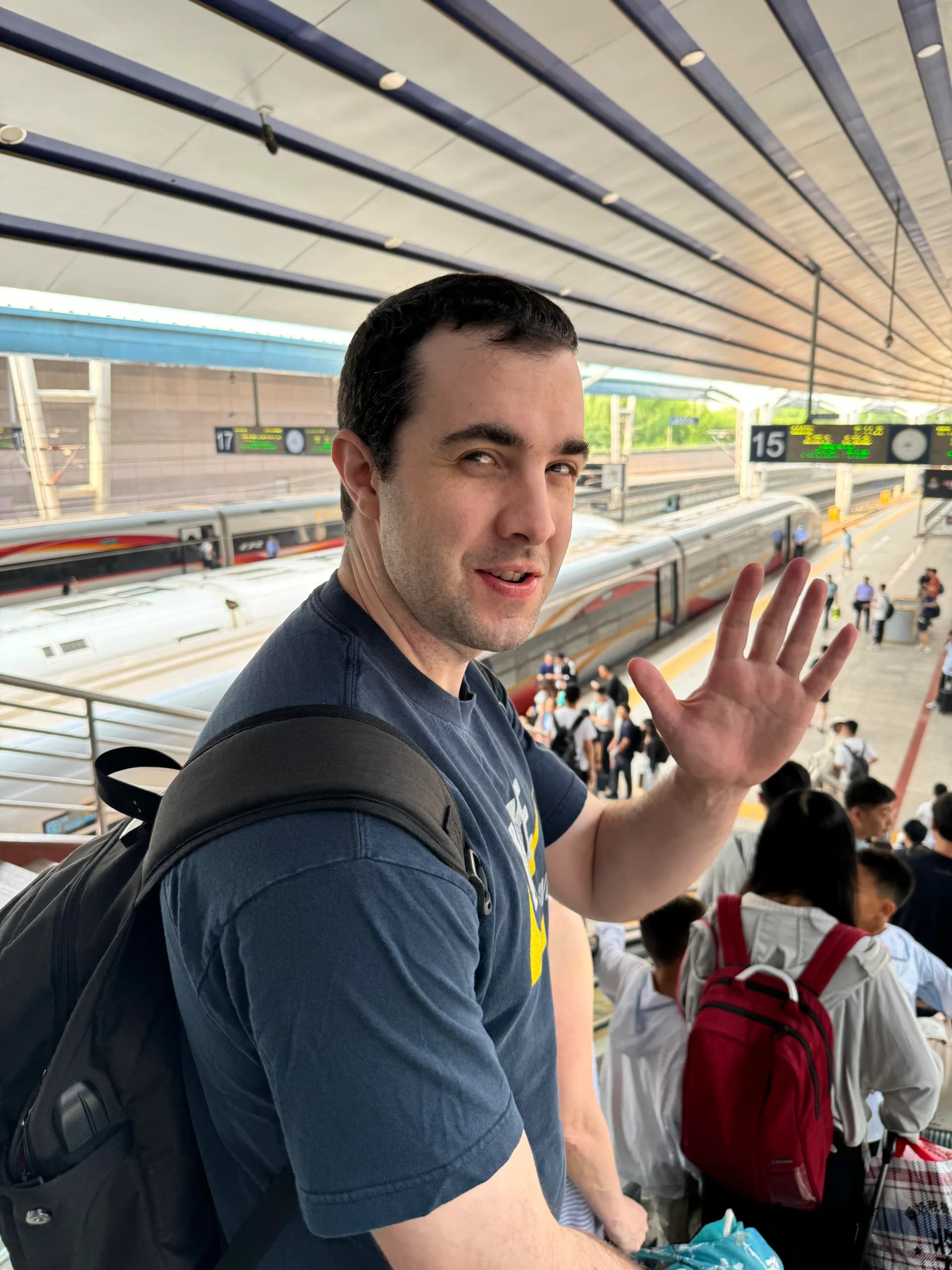 International traveler beside a high-speed train platform in China