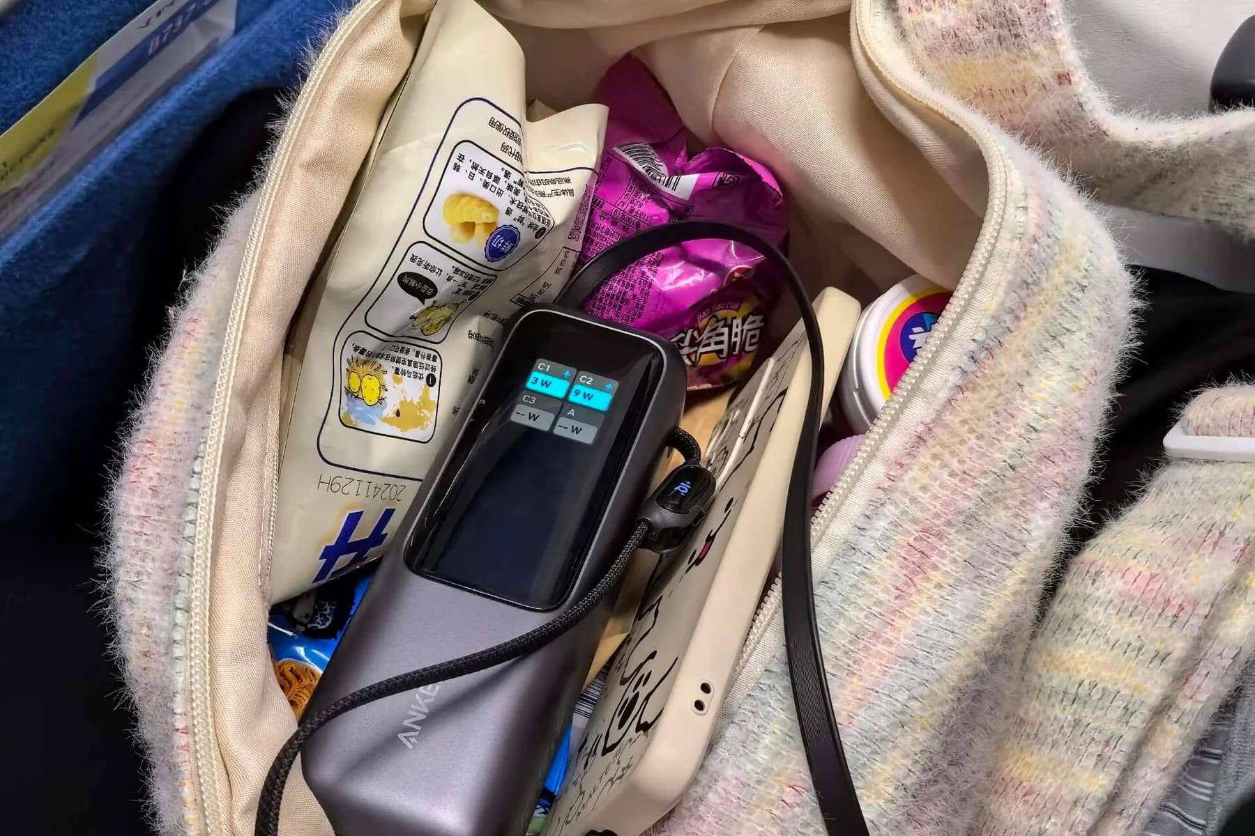 Power bank and charging cable inside a passenger's carry-on bag