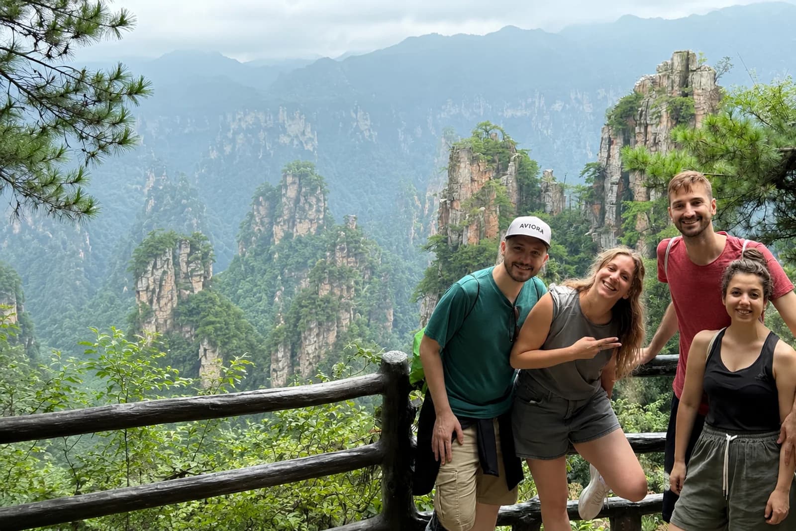 International travelers looking across Zhangjiajie's sandstone peaks in soft mountain light