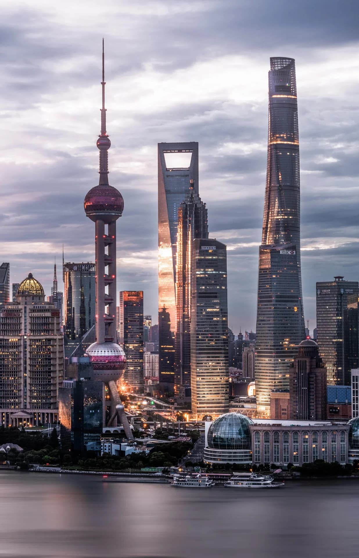 Shanghai's Pudong skyline glowing beside the Huangpu River at dusk
